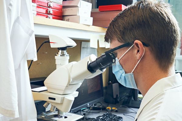 Scientist looking through a microscope