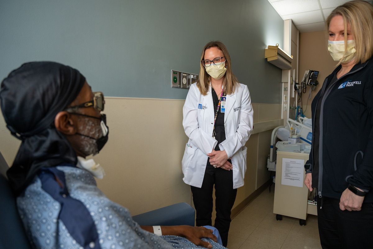 Two Roswell Park nutritionists speak with a male patient 